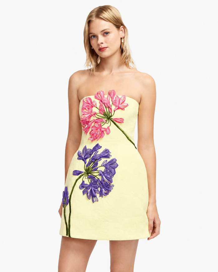 Leo Lin Roselle Appliqué Bustier Mini Dress in sherbet yellow featuring pink and purple 3D agapanthus floral embroidery, strapless neckline and A-line silhouette.