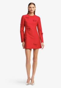 LEO LIN Aliza Bow Long Sleeve Mini Dress in Vermilion available for designer dress hire at Your Secret Closet, featuring handcrafted bow embellishments and structured shoulders.