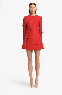 Model wearing the LEO LIN Aliza Bow Long Sleeve Mini Dress in Vermilion for weddings, Spring Racing and cocktail events, available for designer dress hire Australia-wide.